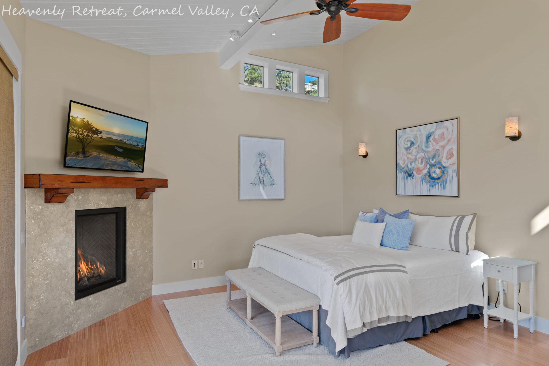 A bedroom with a fireplace and a large bed