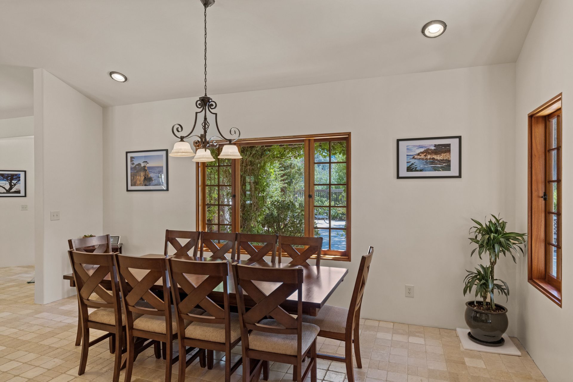 A dining room with a table and chairs and a window.