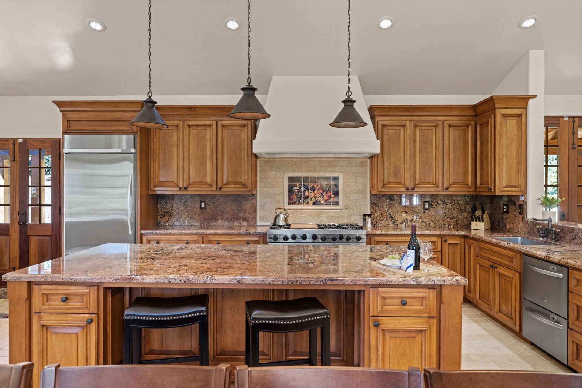 A kitchen with wooden cabinets and granite counter tops