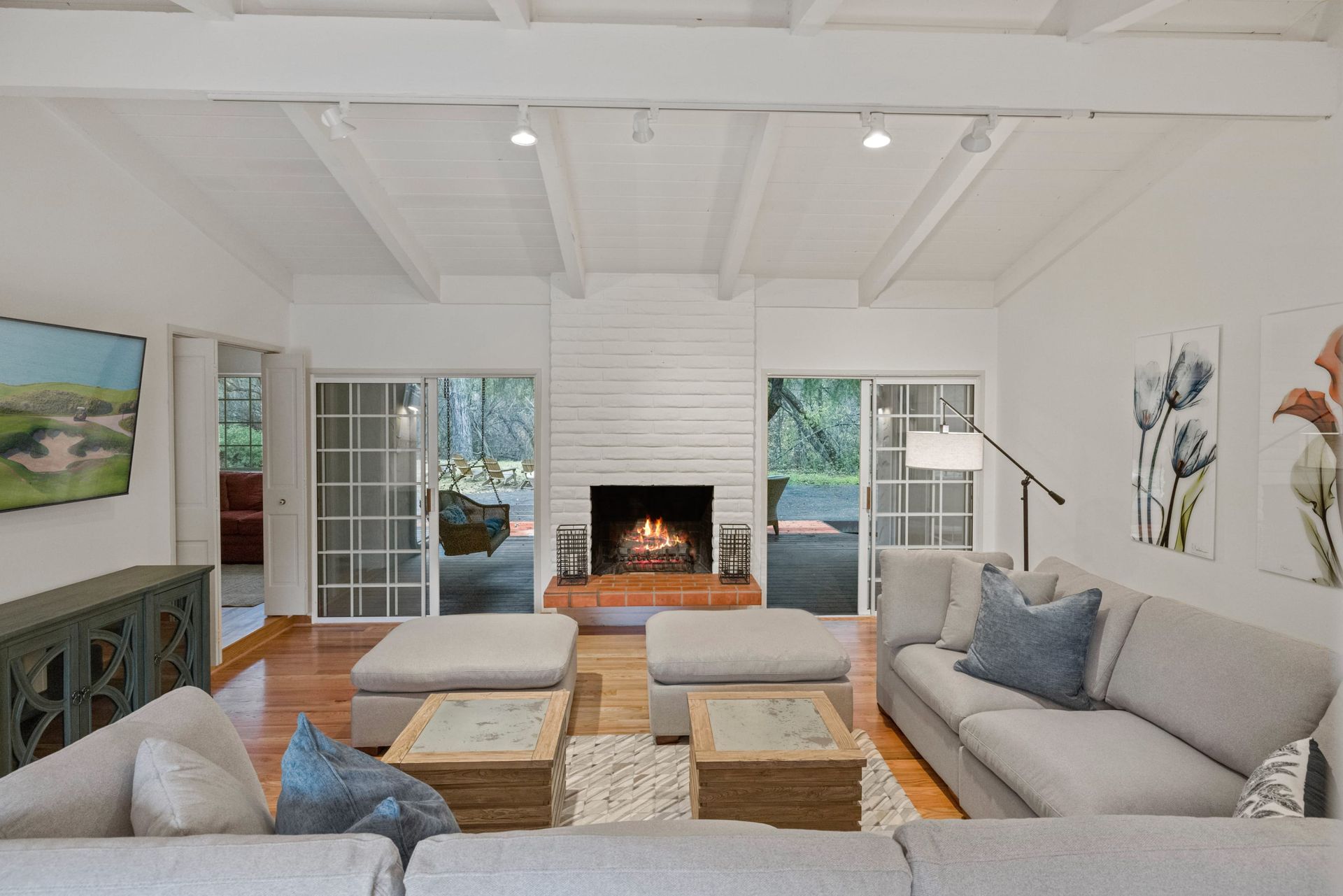 A house with a driveway and trees in the background