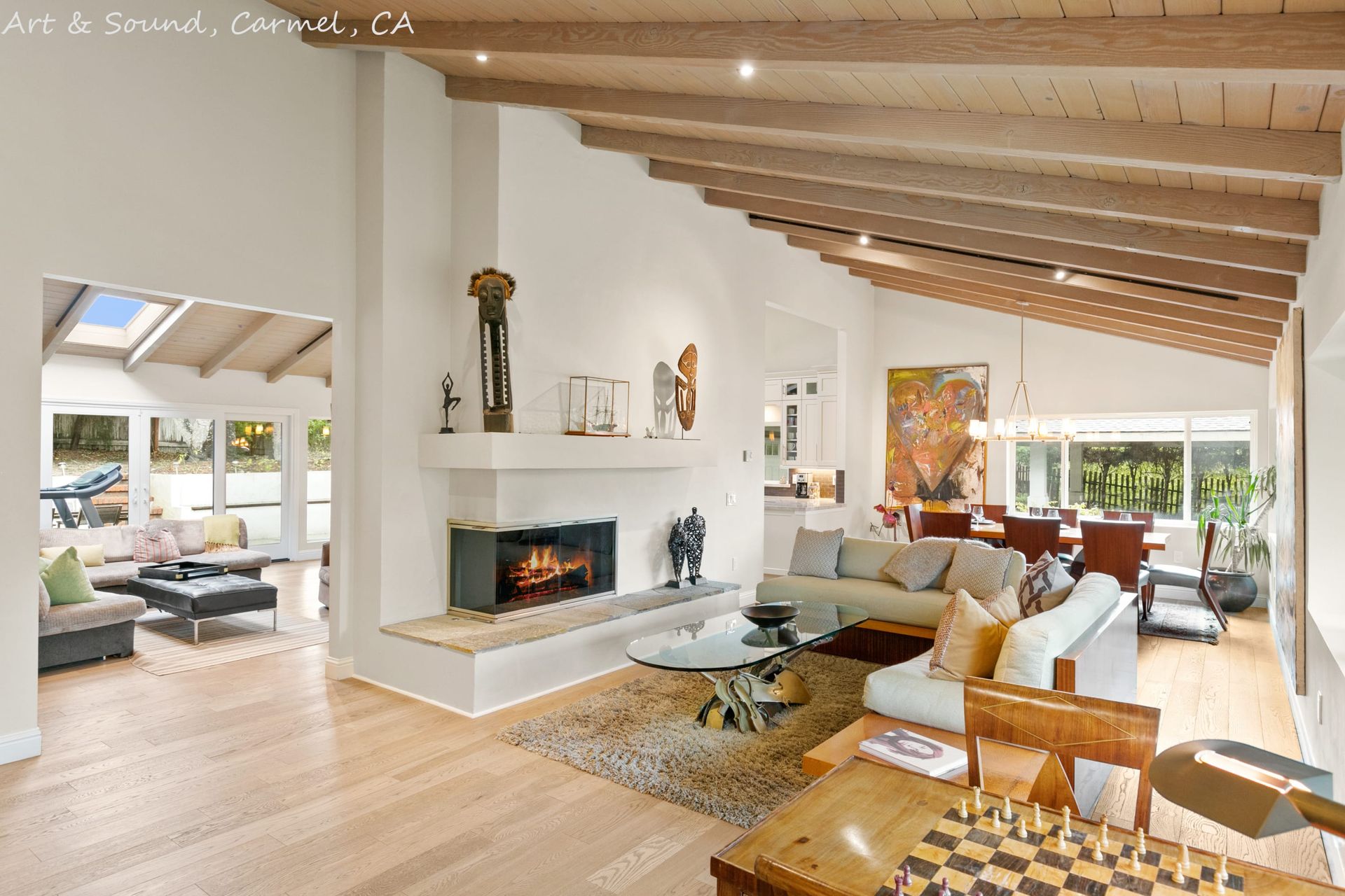 A living room with a fireplace and a chess board