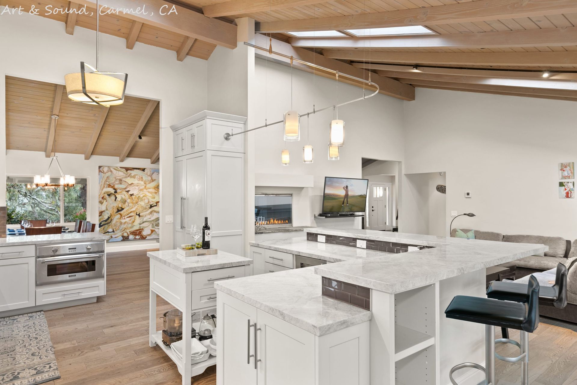 A large kitchen with white cabinets and granite counter tops