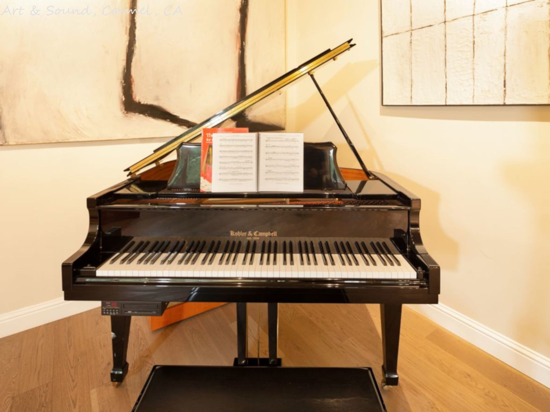 A grand piano with a book on top of it