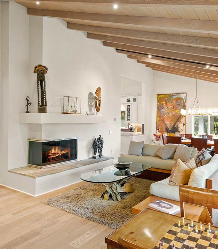 A living room with a fireplace and a chess board