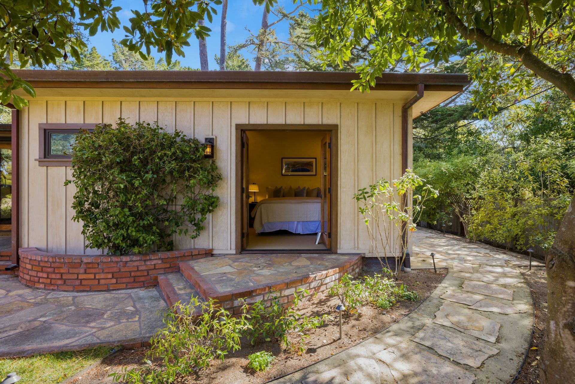 A small house with a bedroom in the backyard.