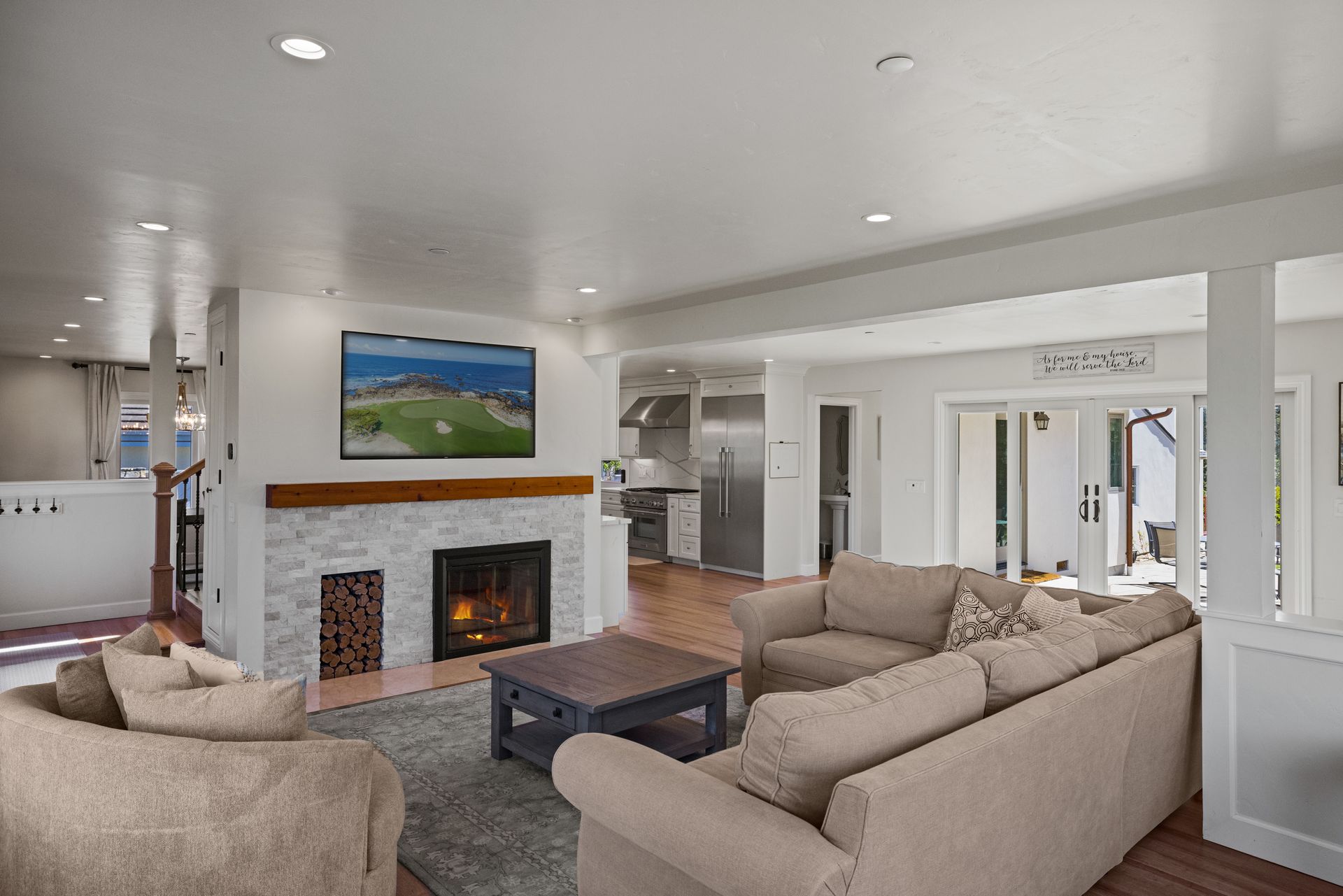 A living room with a couch , chairs , coffee table and fireplace.