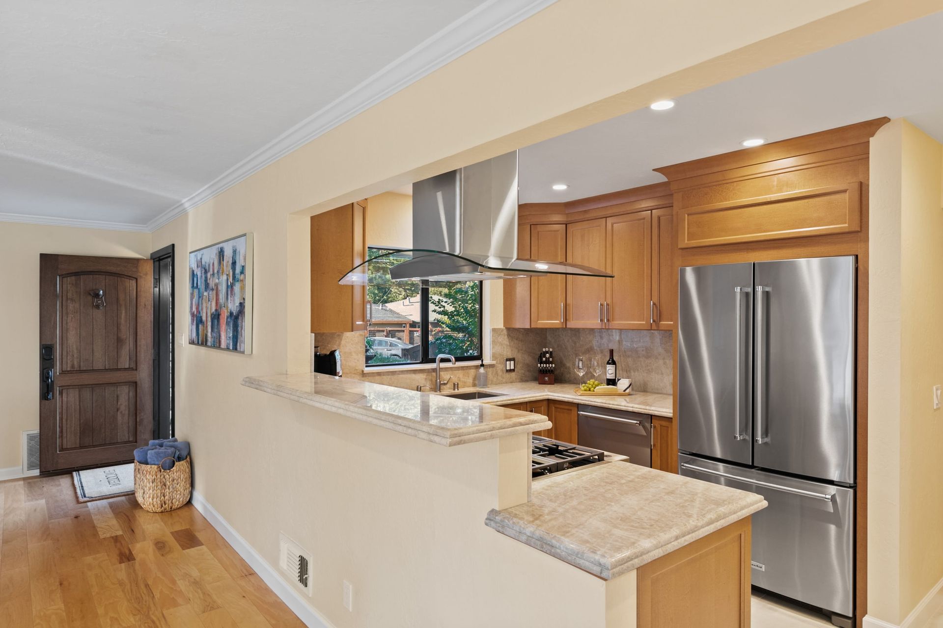 A kitchen with stainless steel appliances and wooden cabinets
