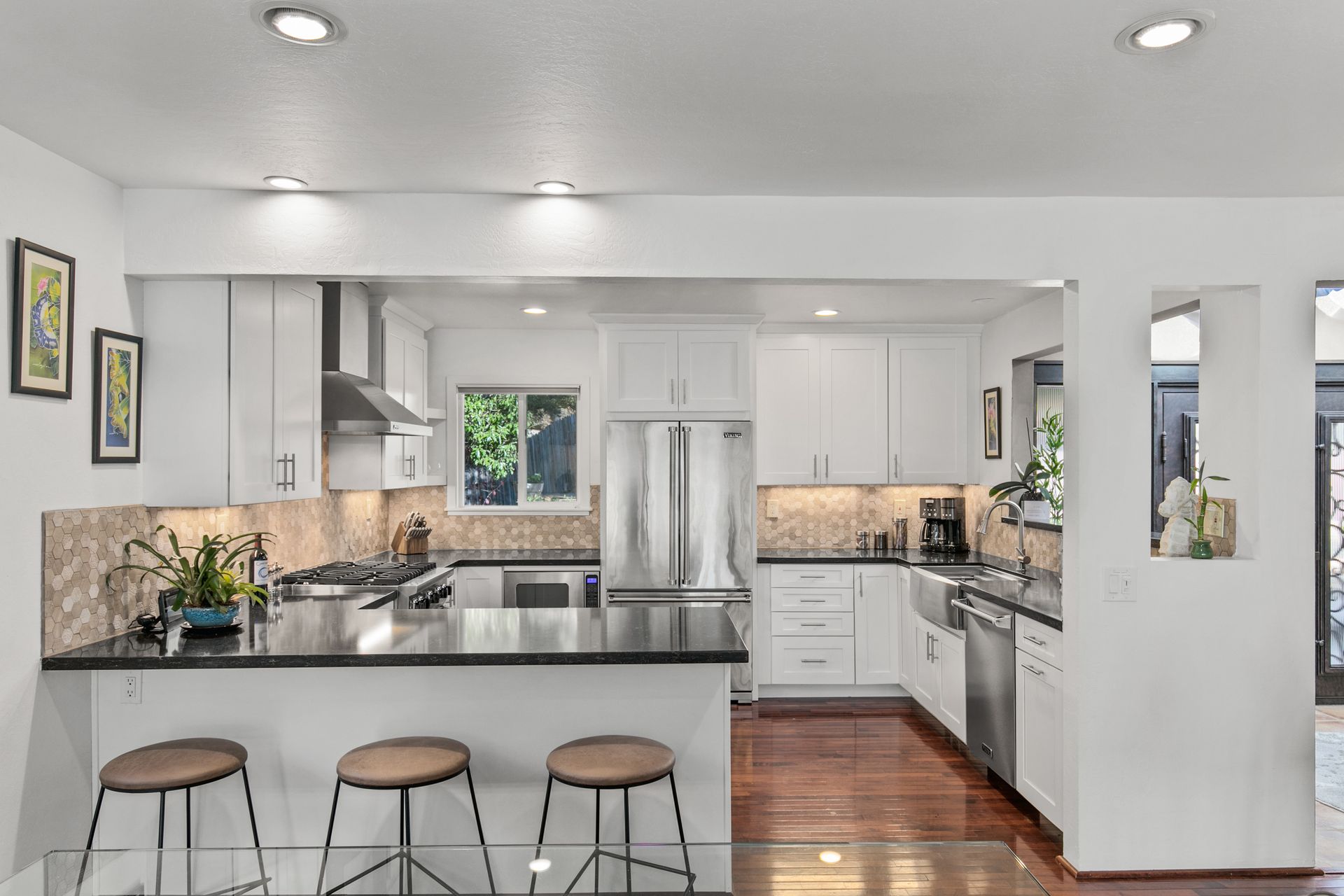 A patio with a table and chairs and a fire pit.