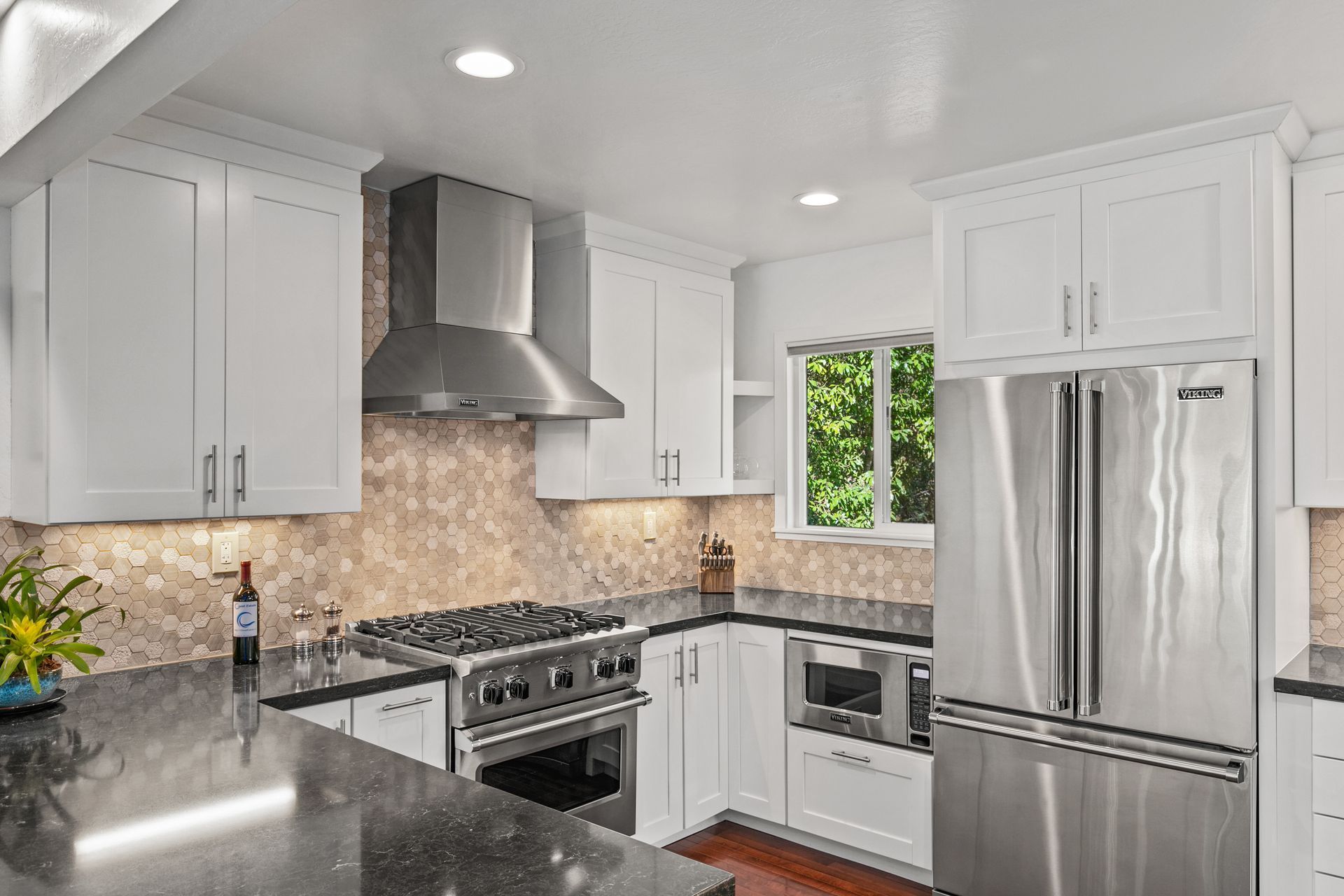 A kitchen with stainless steel appliances and white cabinets
