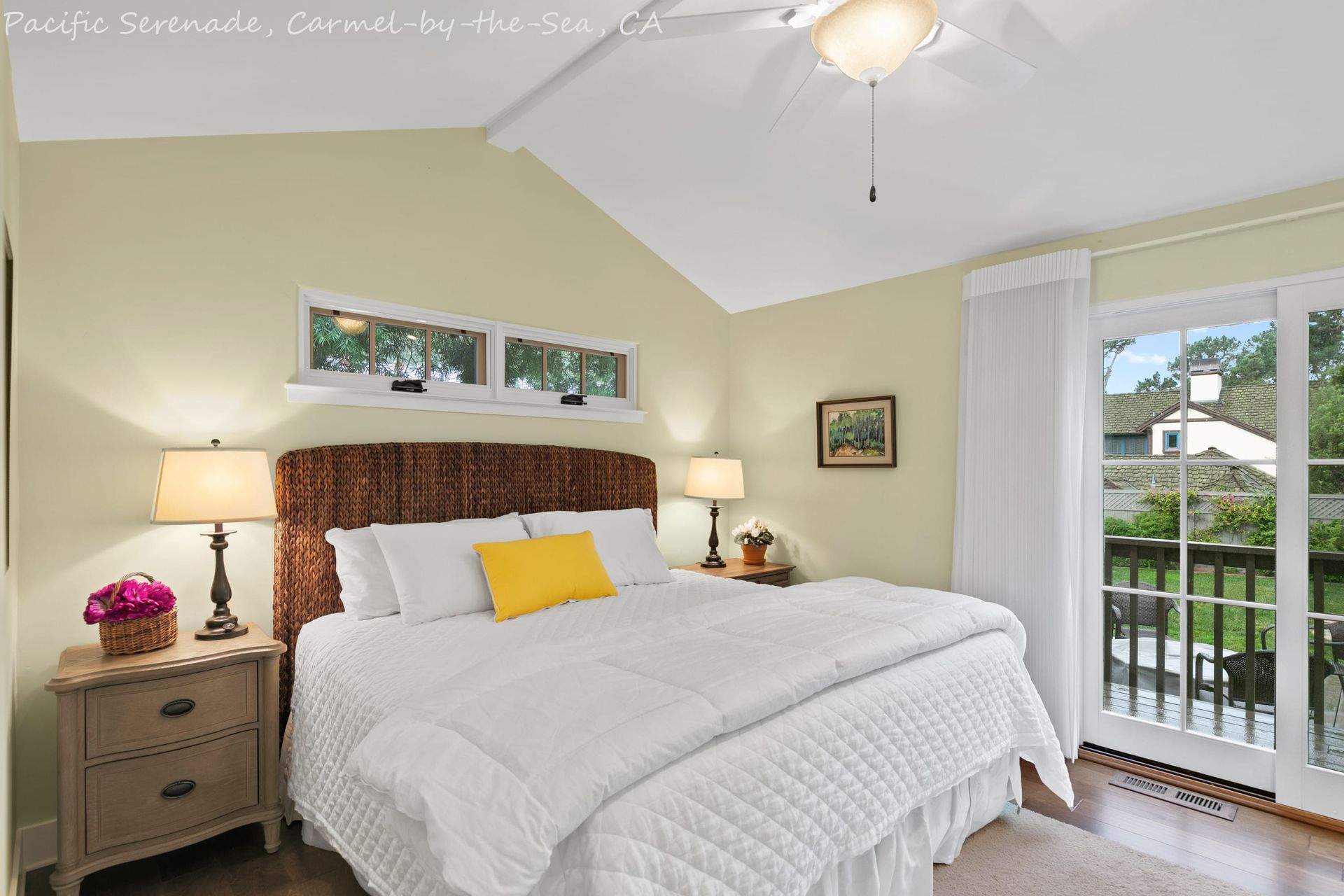 A bedroom with a king size bed and a sliding glass door
