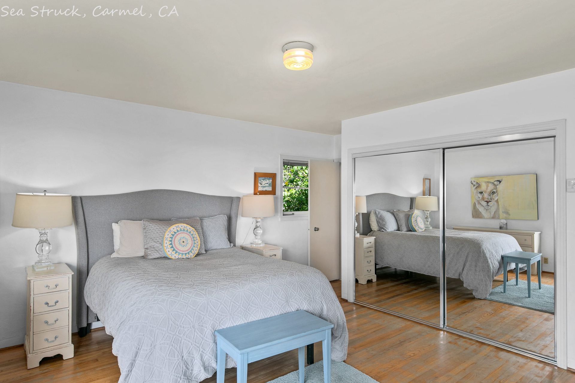 A bedroom with a king size bed and a sliding glass door.