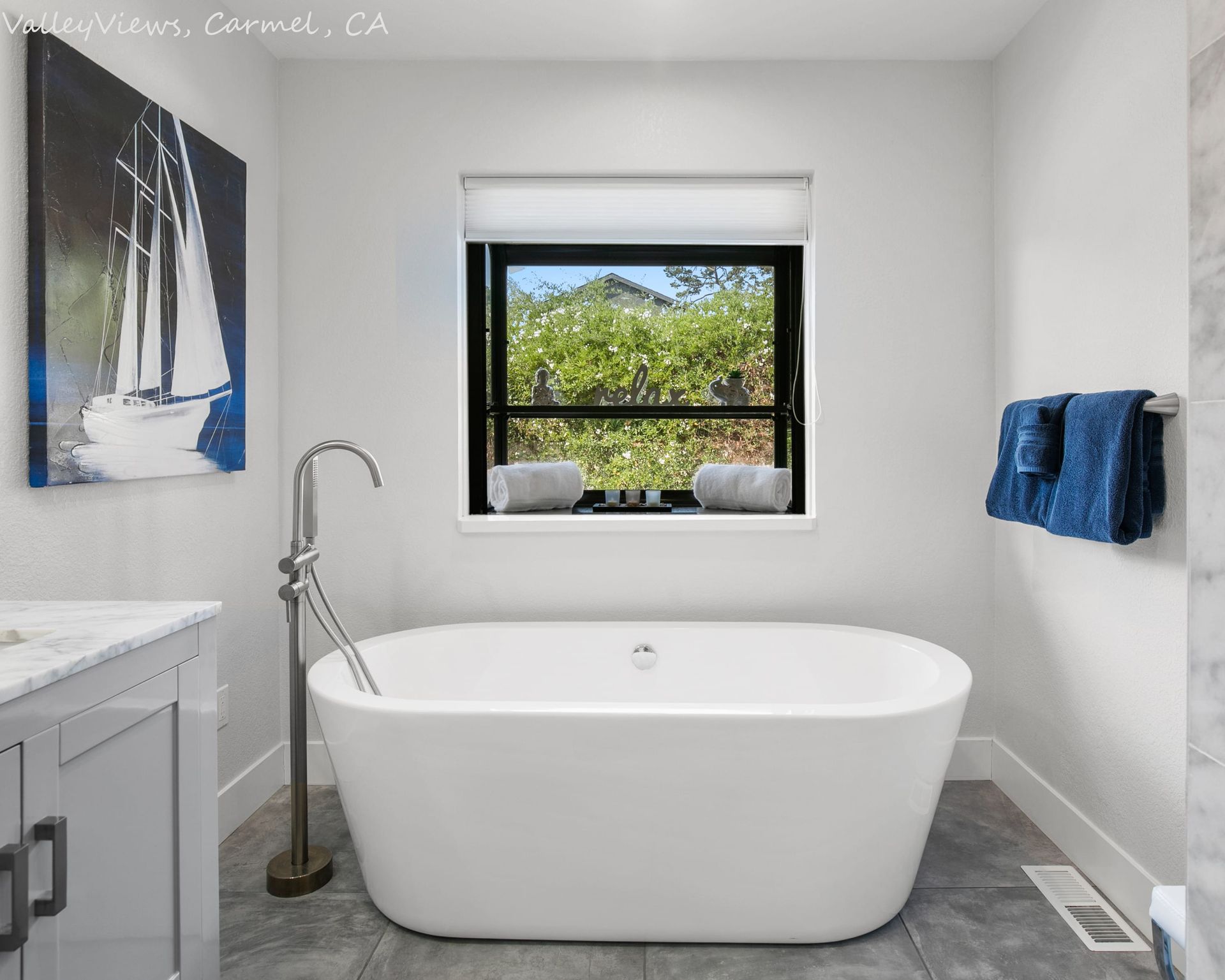 A bathroom with a bathtub and a window