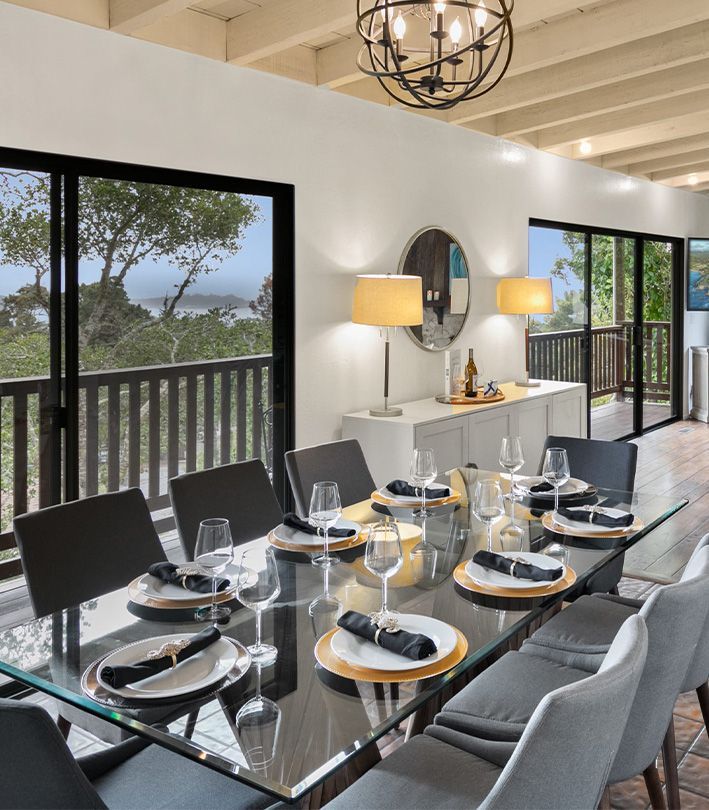 A dining room with a glass table and chairs