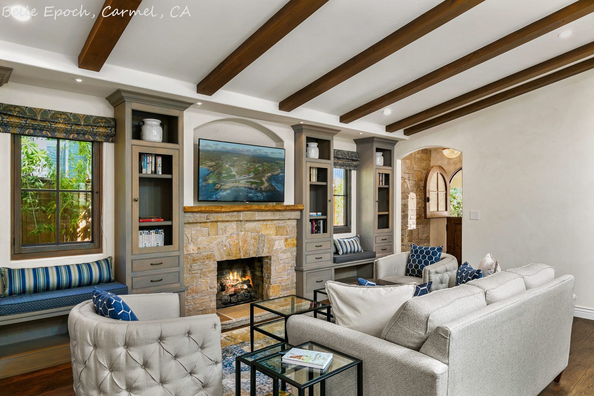A living room with a couch , chairs , and a fireplace.