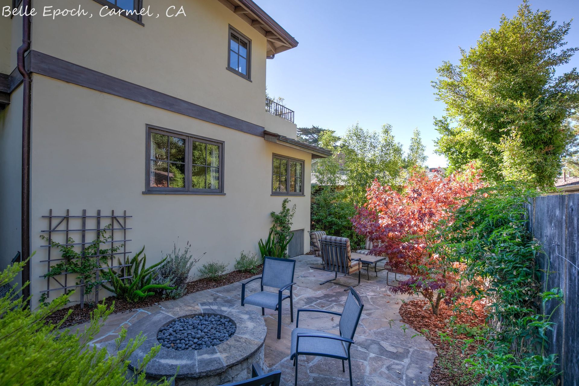 A house with a fire pit in front of it