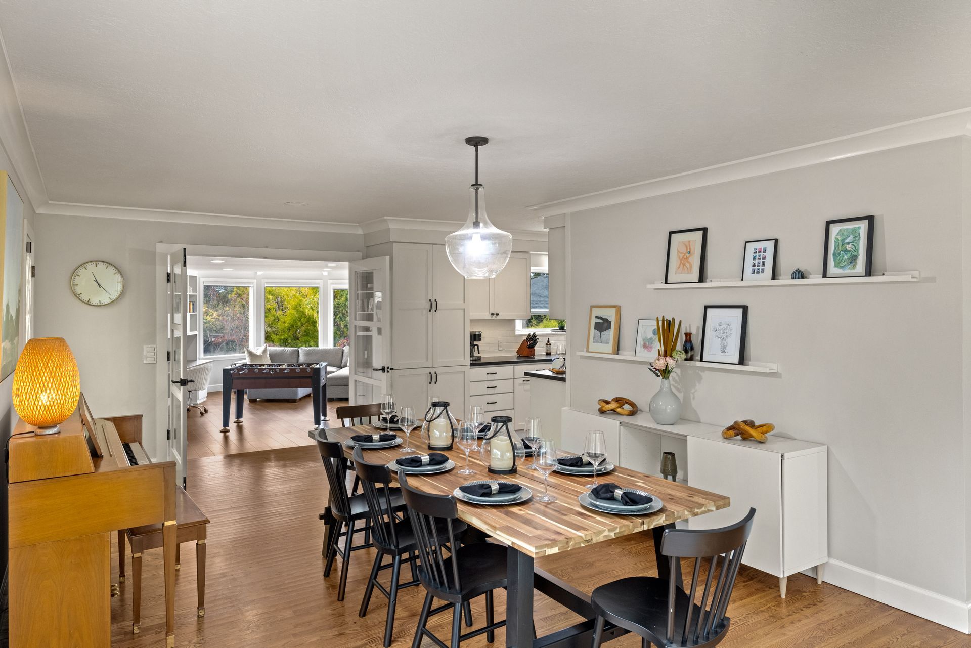 A house with a wooden fence and a brick walkway leading to it.