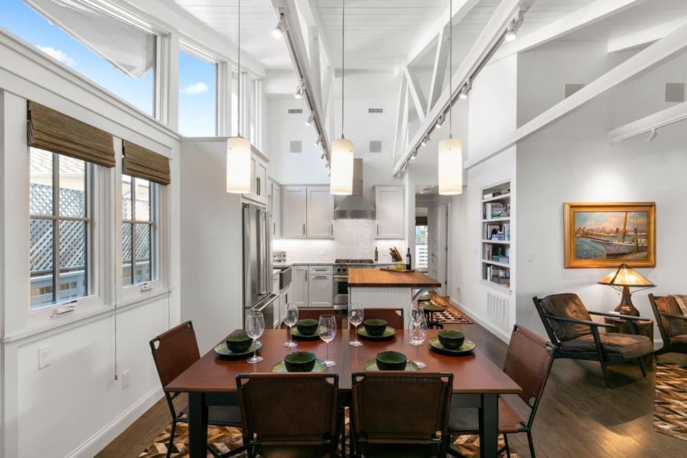 There is a dining table and chairs in the middle of the room.