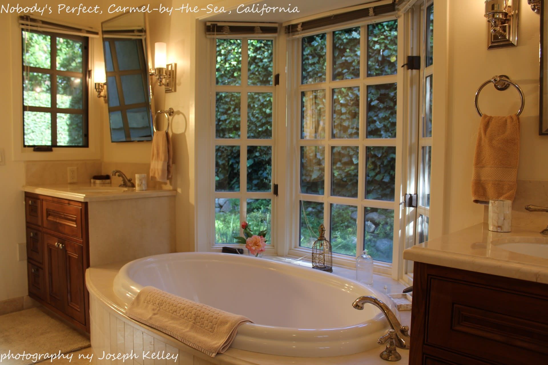A house with a brick fence and a gray garage door