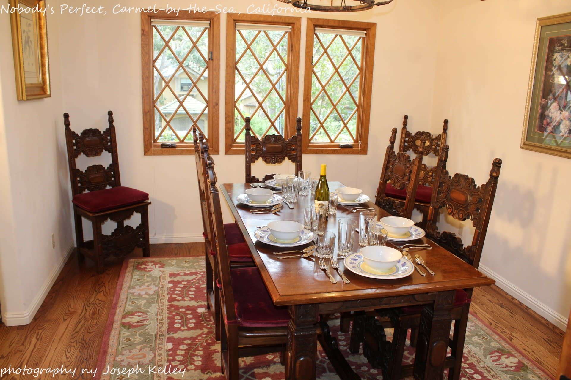 A dining room with a long table and chairs