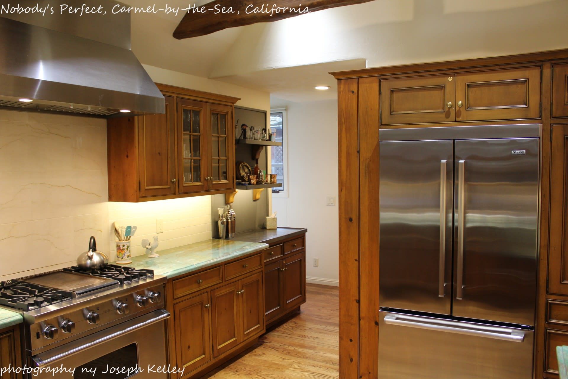 A kitchen with stainless steel appliances and wooden cabinets