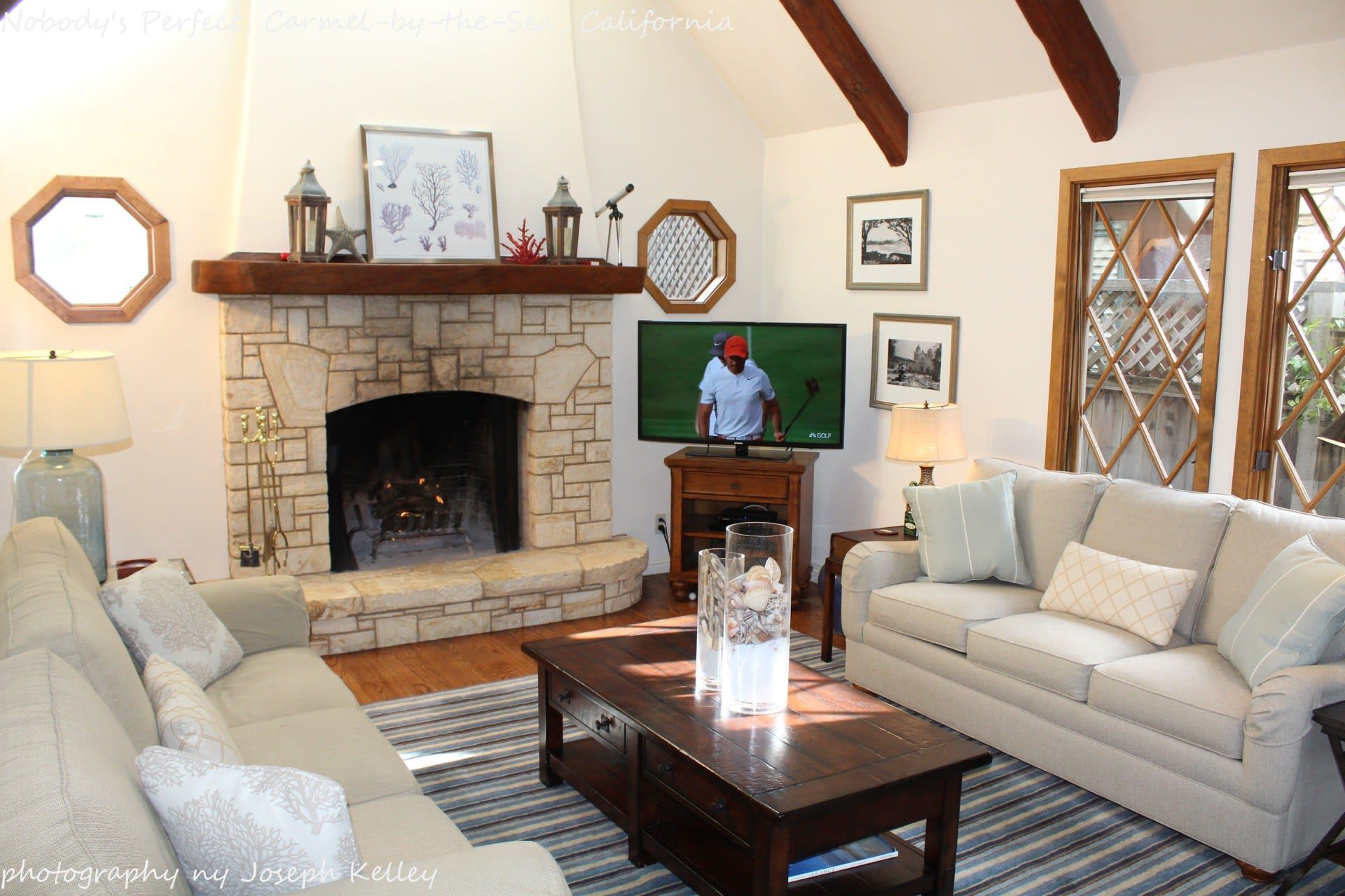 A living room with a fireplace and a flat screen tv