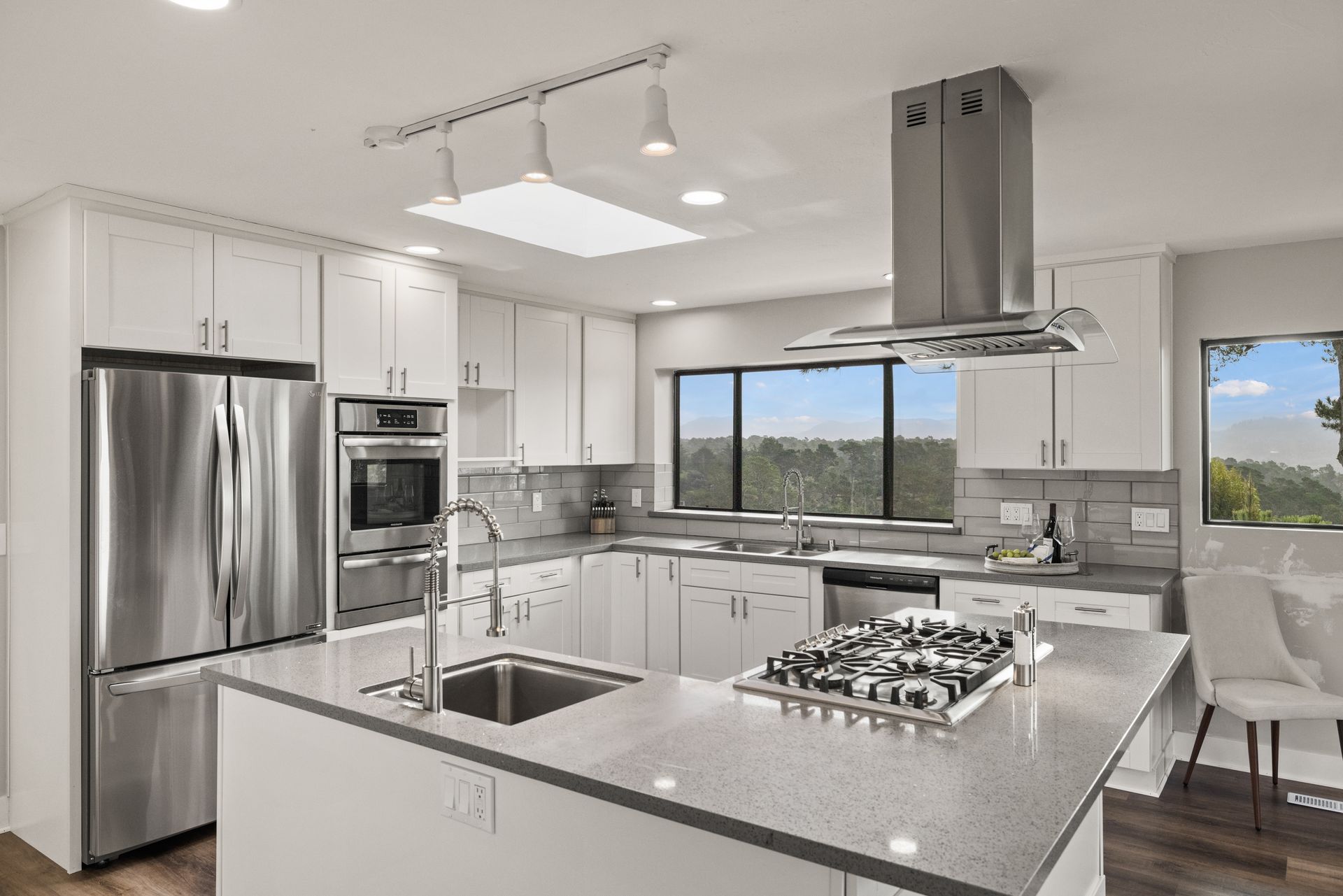 A kitchen with white cabinets and stainless steel appliances