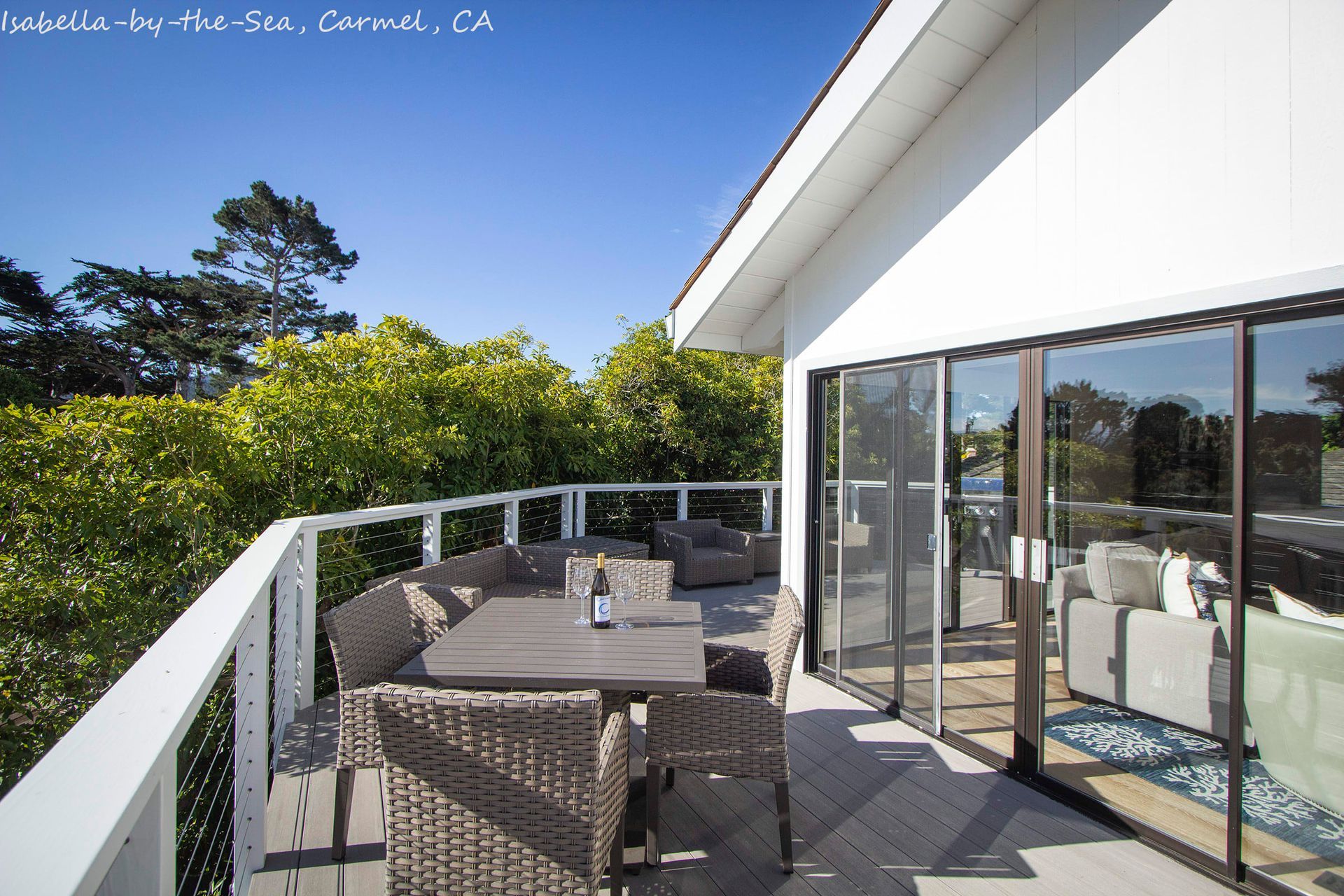 A balcony with wicker chairs and a table in california