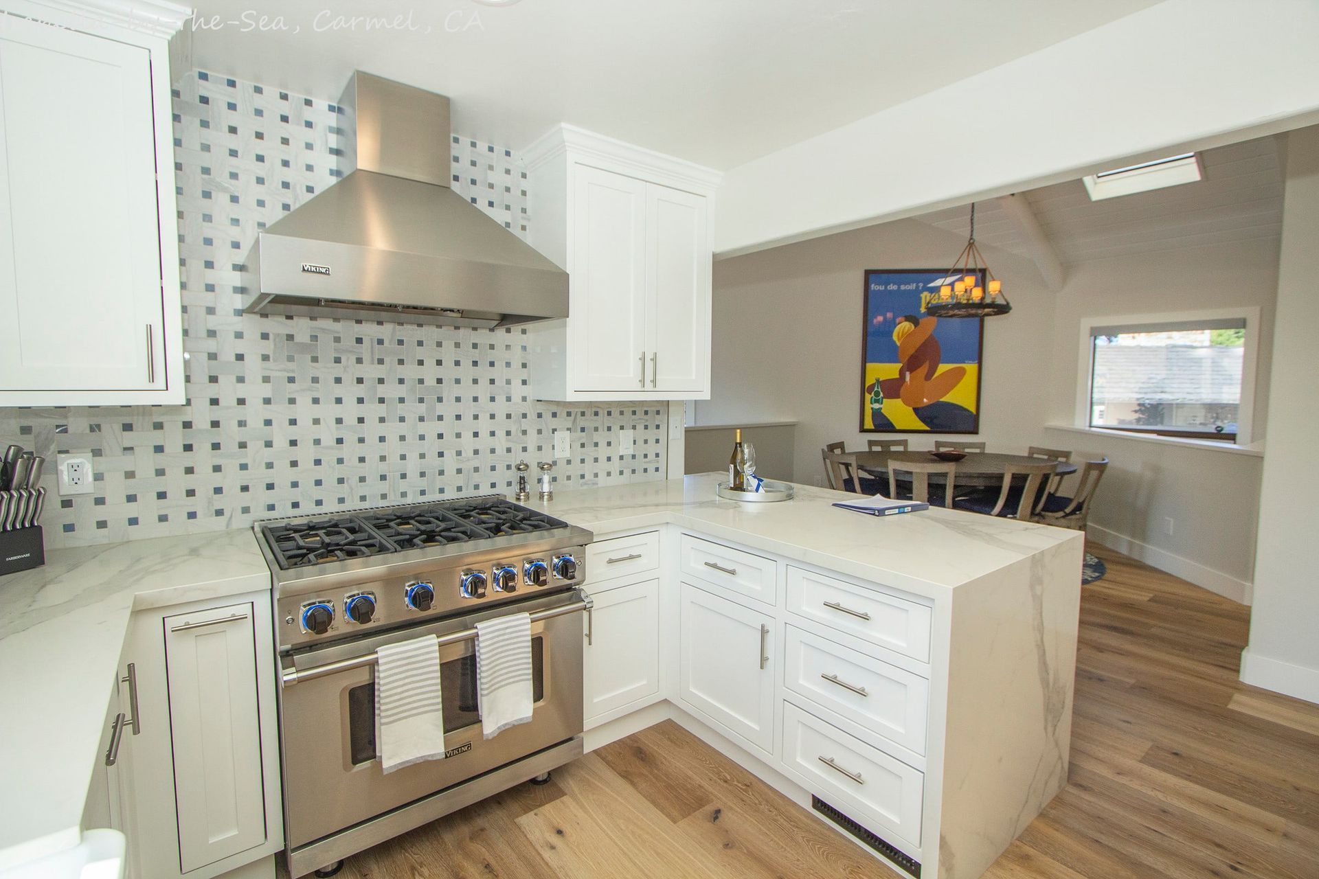 A kitchen with stainless steel appliances and white cabinets