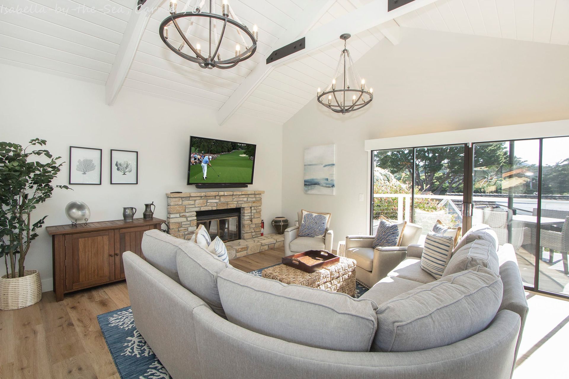 A living room with a couch , chairs , fireplace and television.
