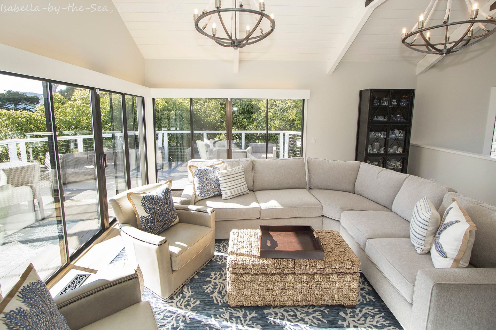 A white house with a gray garage door and stairs