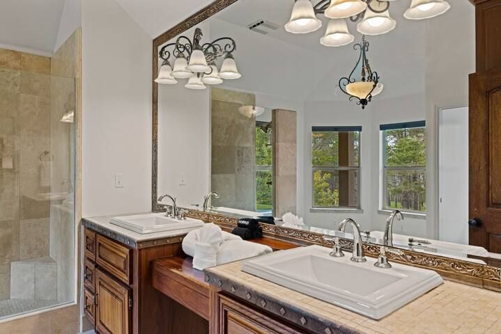 A bathroom with two sinks and a large mirror.