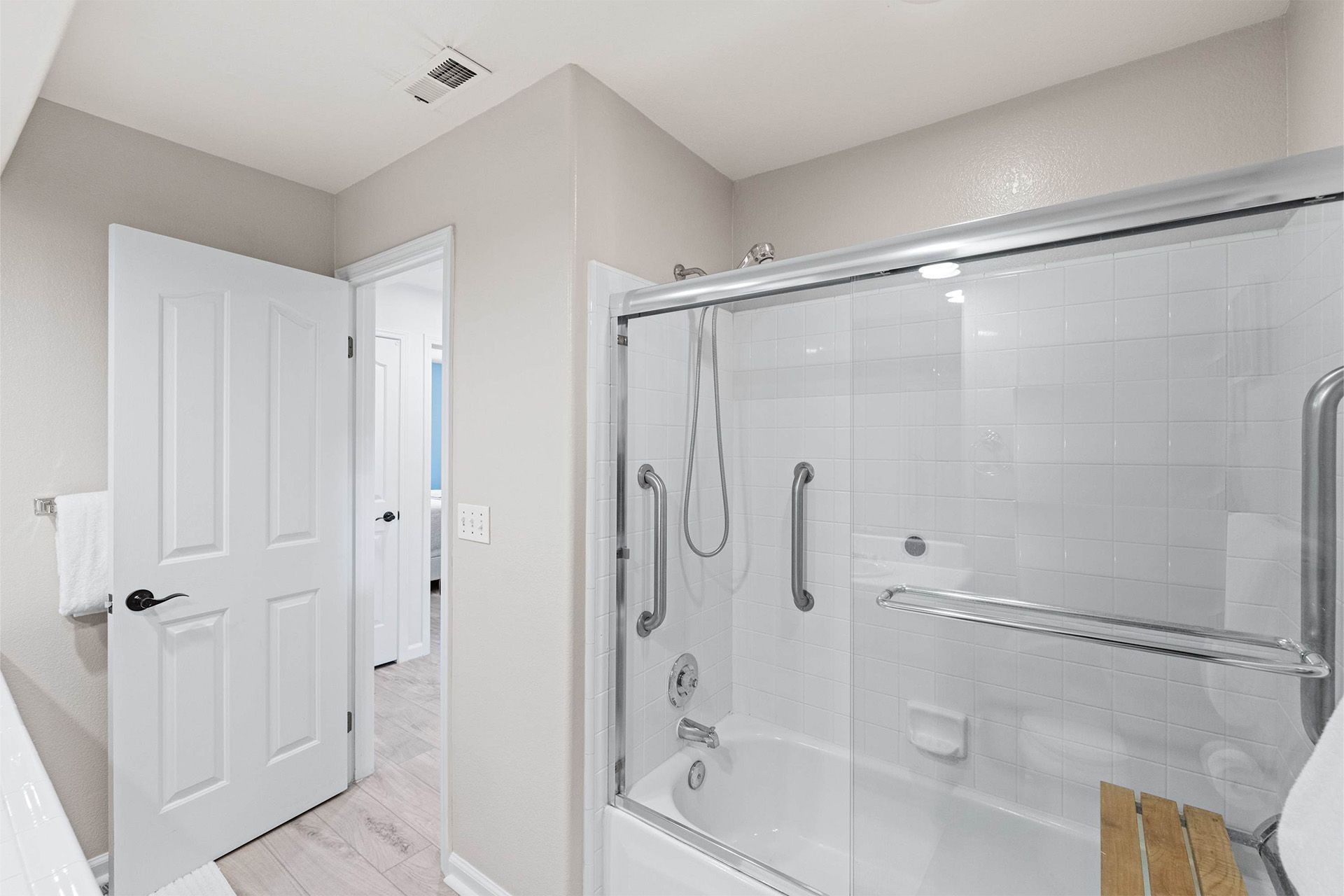 A bathroom with a bathtub and a shower stall.