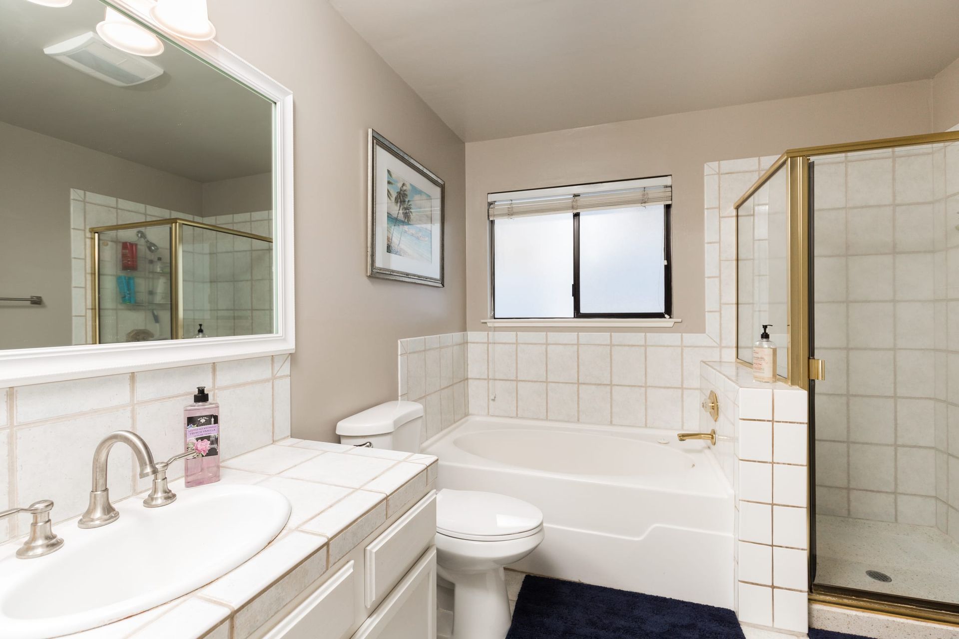 A bathroom with a sink , toilet , tub and shower.