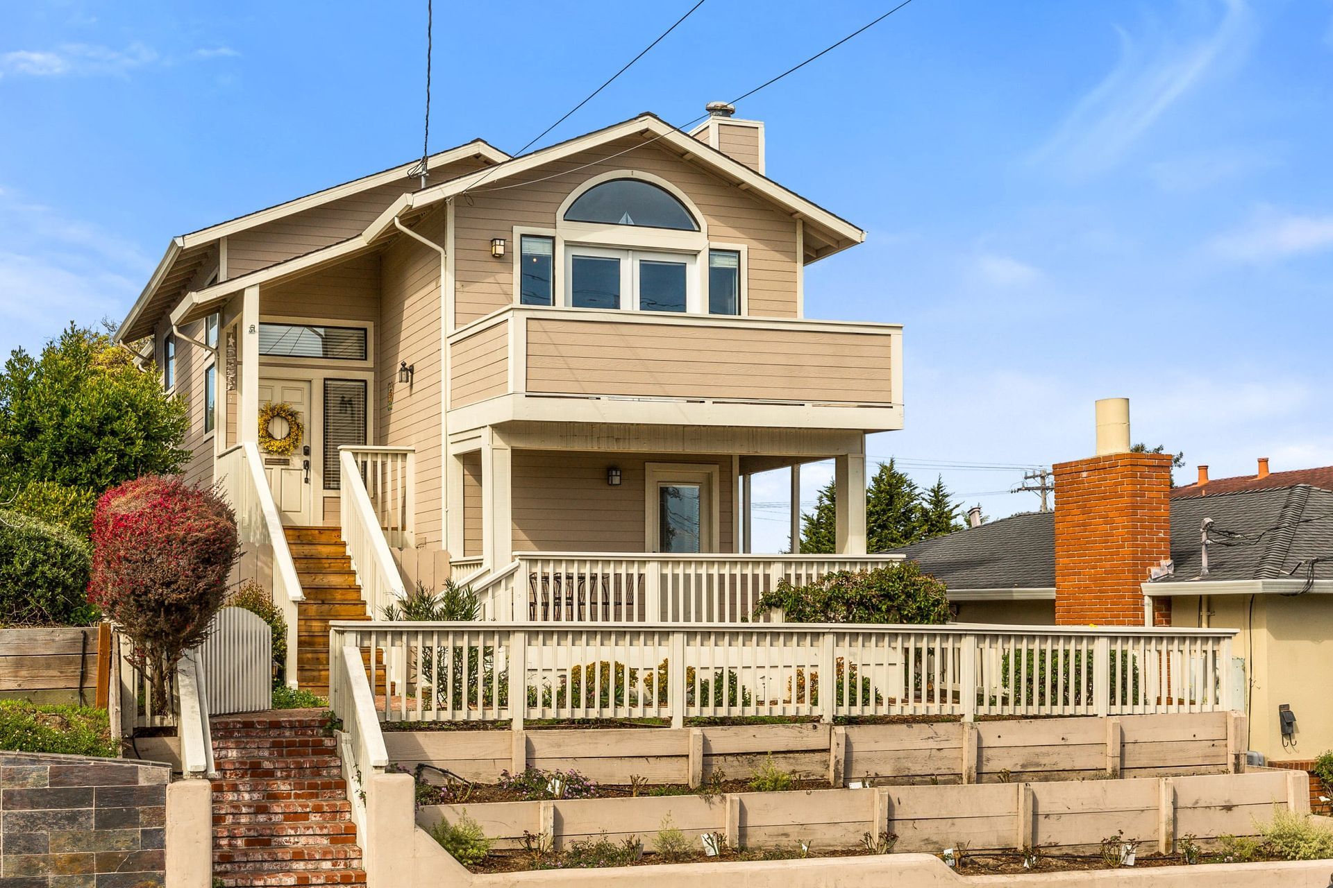 A large house with a balcony and stairs is for sale.