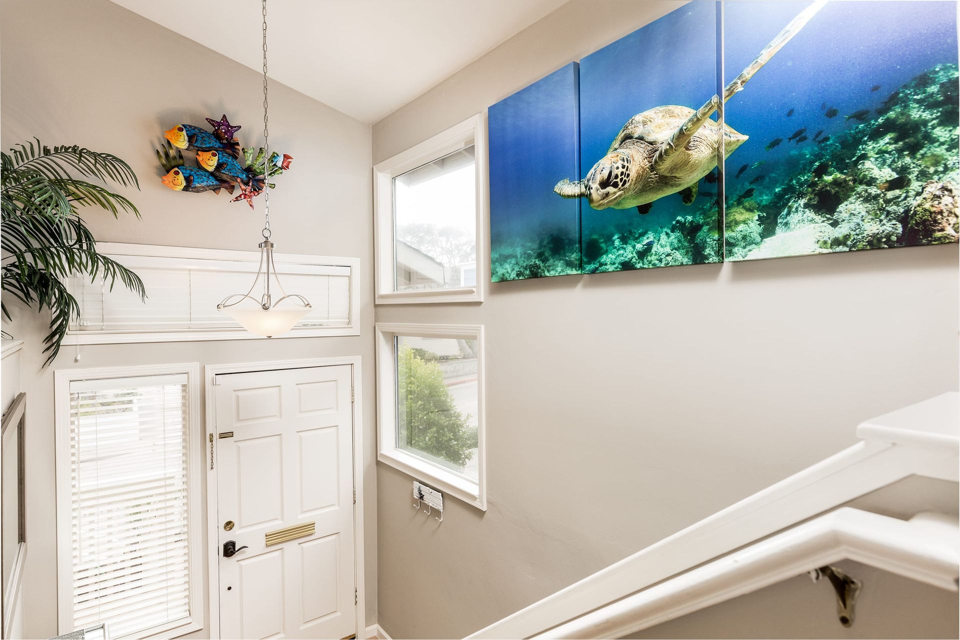 A staircase with a picture of a sea turtle on the wall.