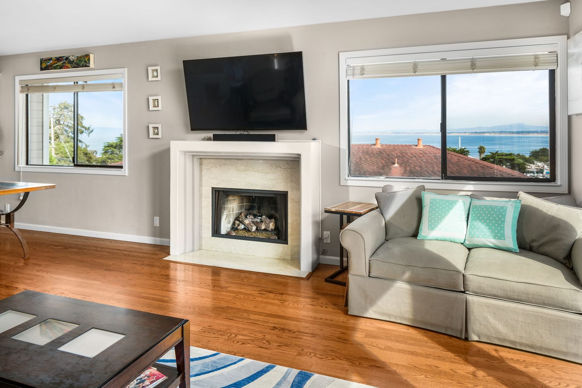 A living room with a couch , fireplace and television.