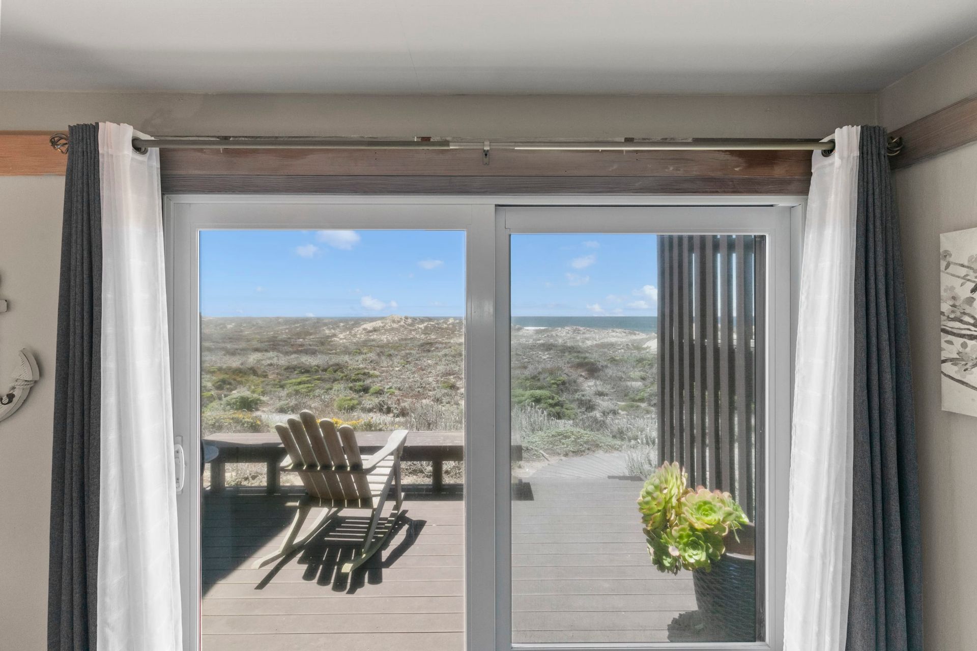A room with a sliding glass door leading to a deck.