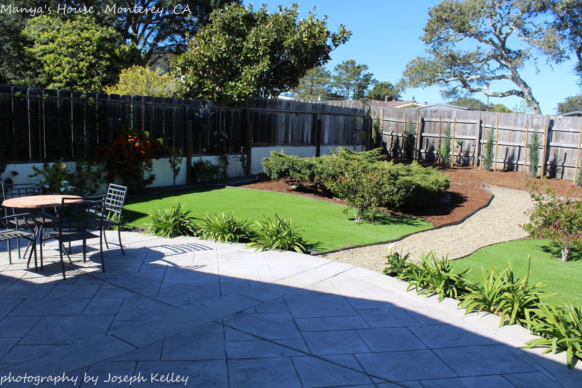 A patio with a table and chairs in the backyard