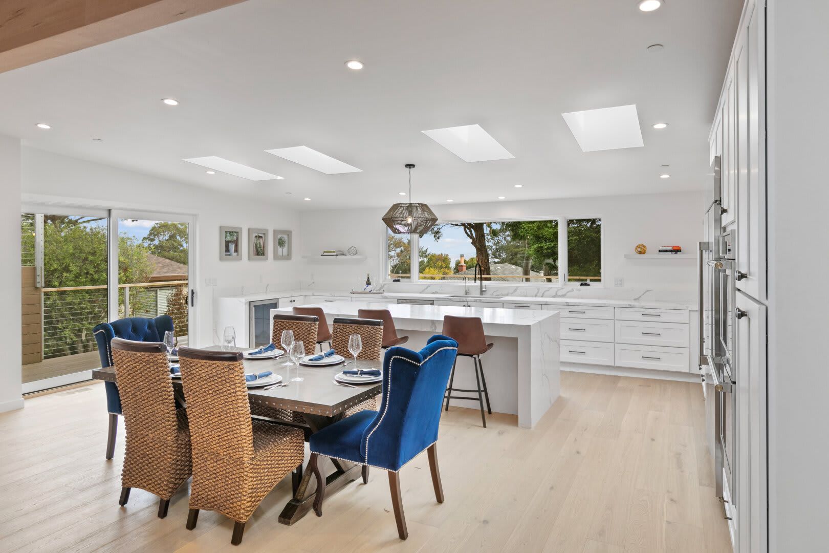 A white house with a tree in front of it