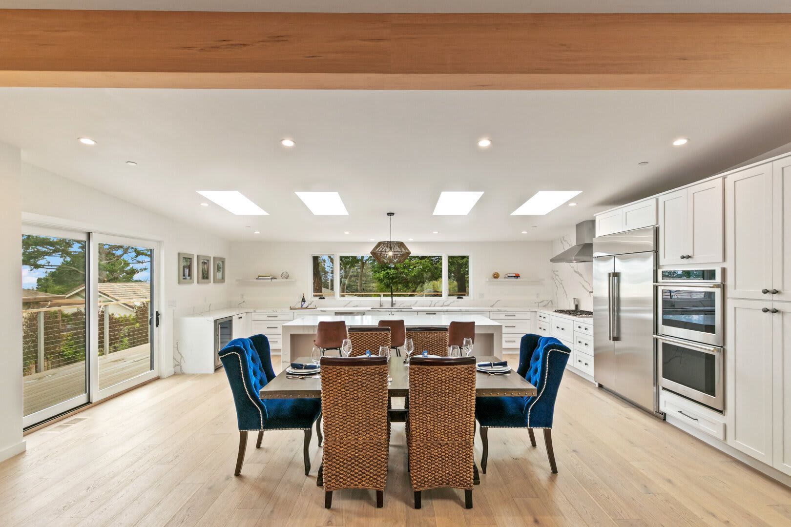 A large kitchen with a dining table and chairs in it.