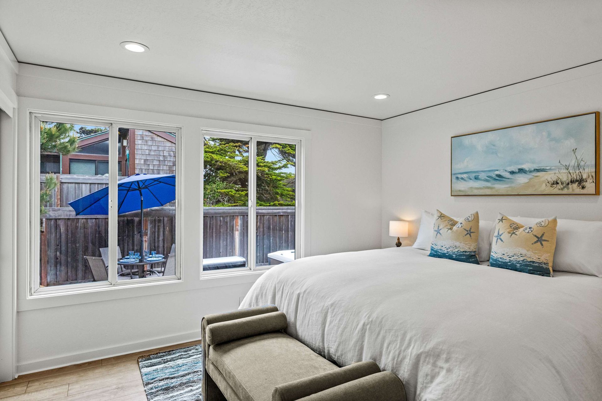 A bedroom with a king size bed and a bench.
