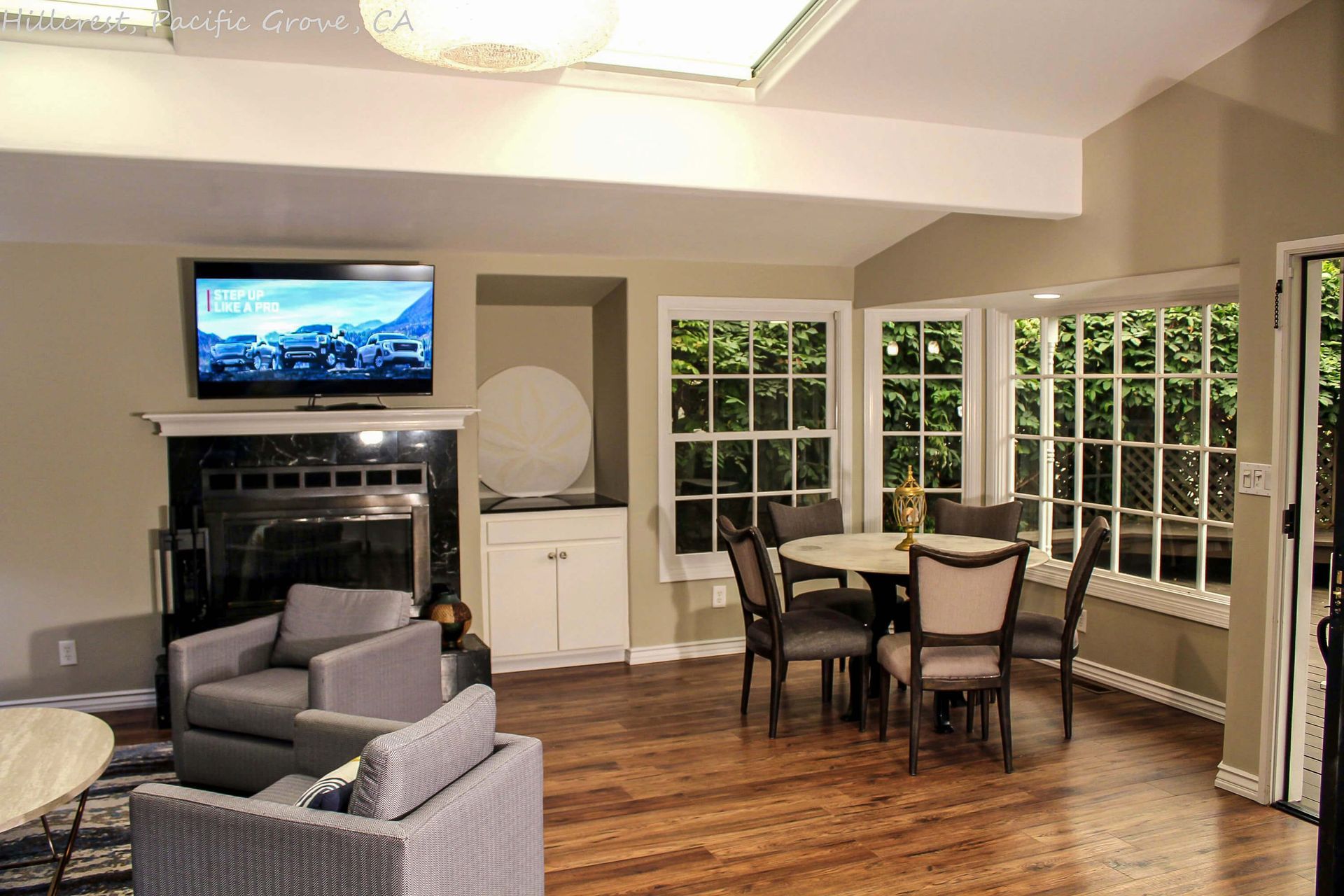 A living room with a flat screen tv above the fireplace