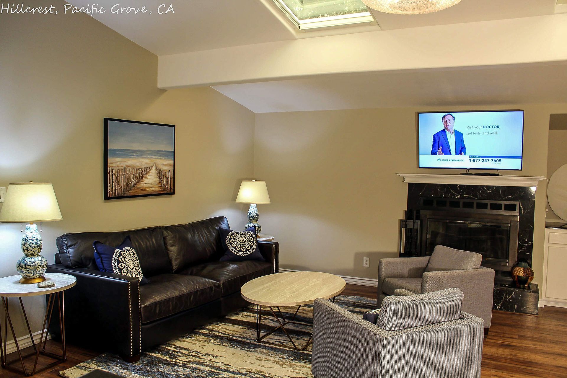 A living room with a black couch and a flat screen tv