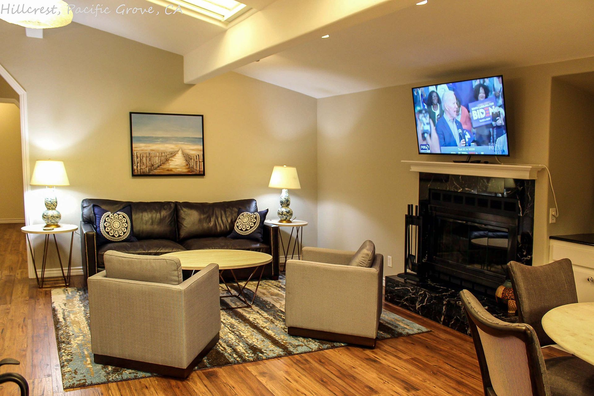 A living room with a fireplace and a flat screen tv