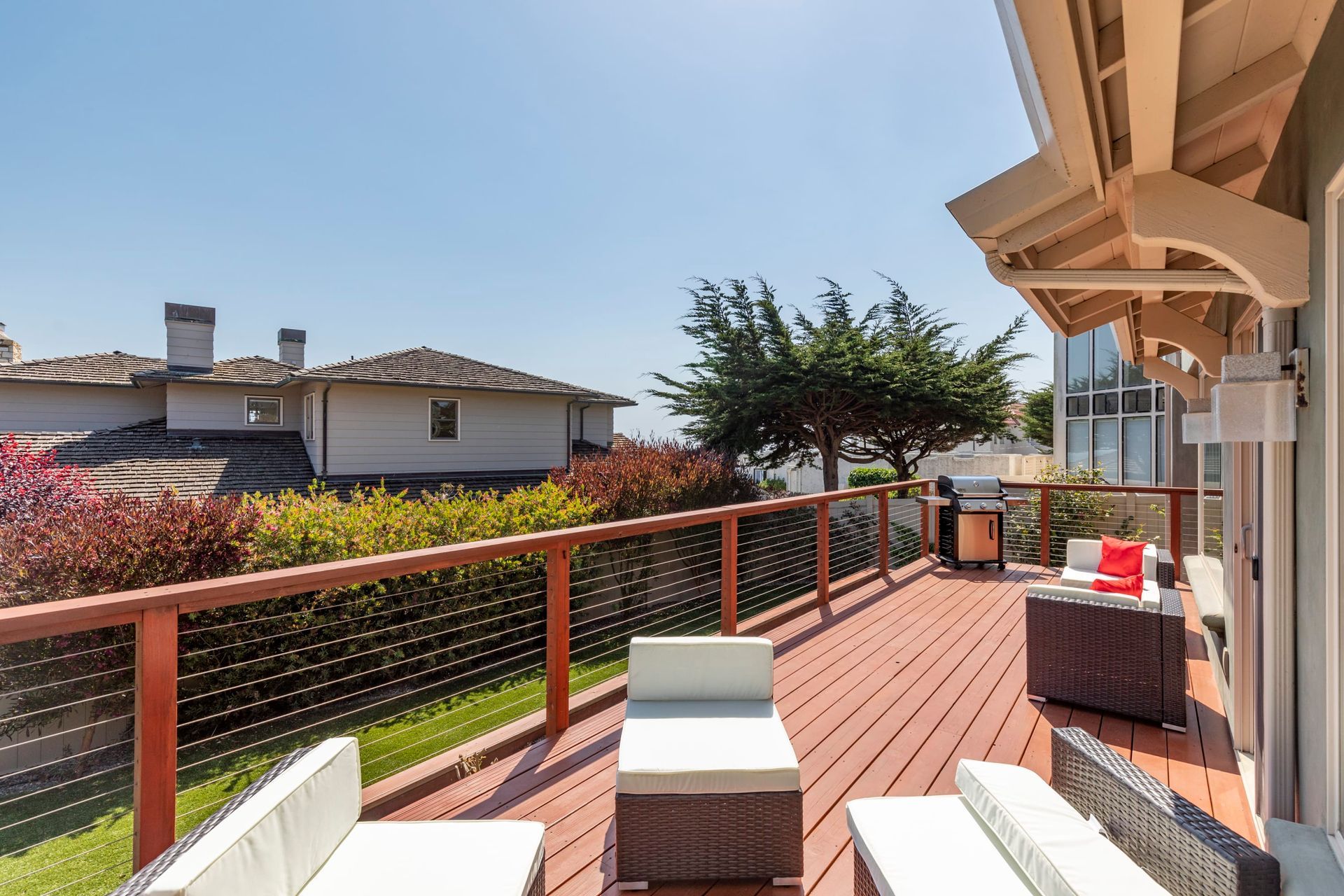 A large deck with a couch and chairs on it
