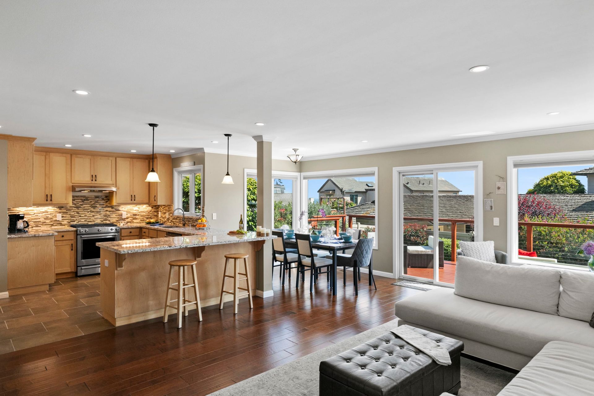 An aerial view of a house with the ocean in the background