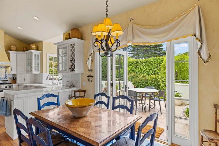 A patio with a table and chairs in front of a house