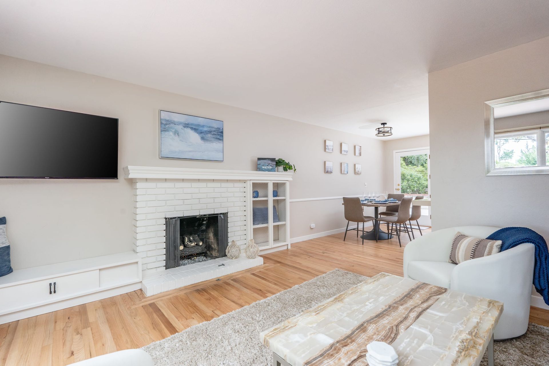 A living room with a fireplace and a flat screen tv.
