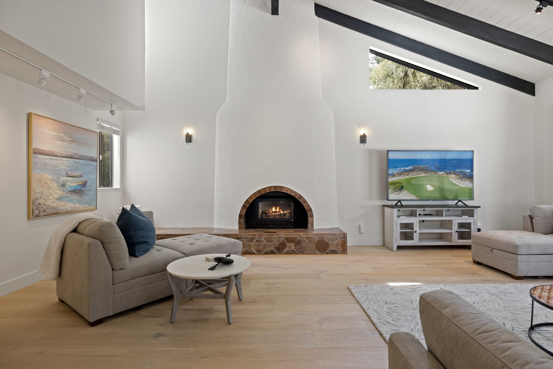 A living room with a fireplace and a flat screen tv.