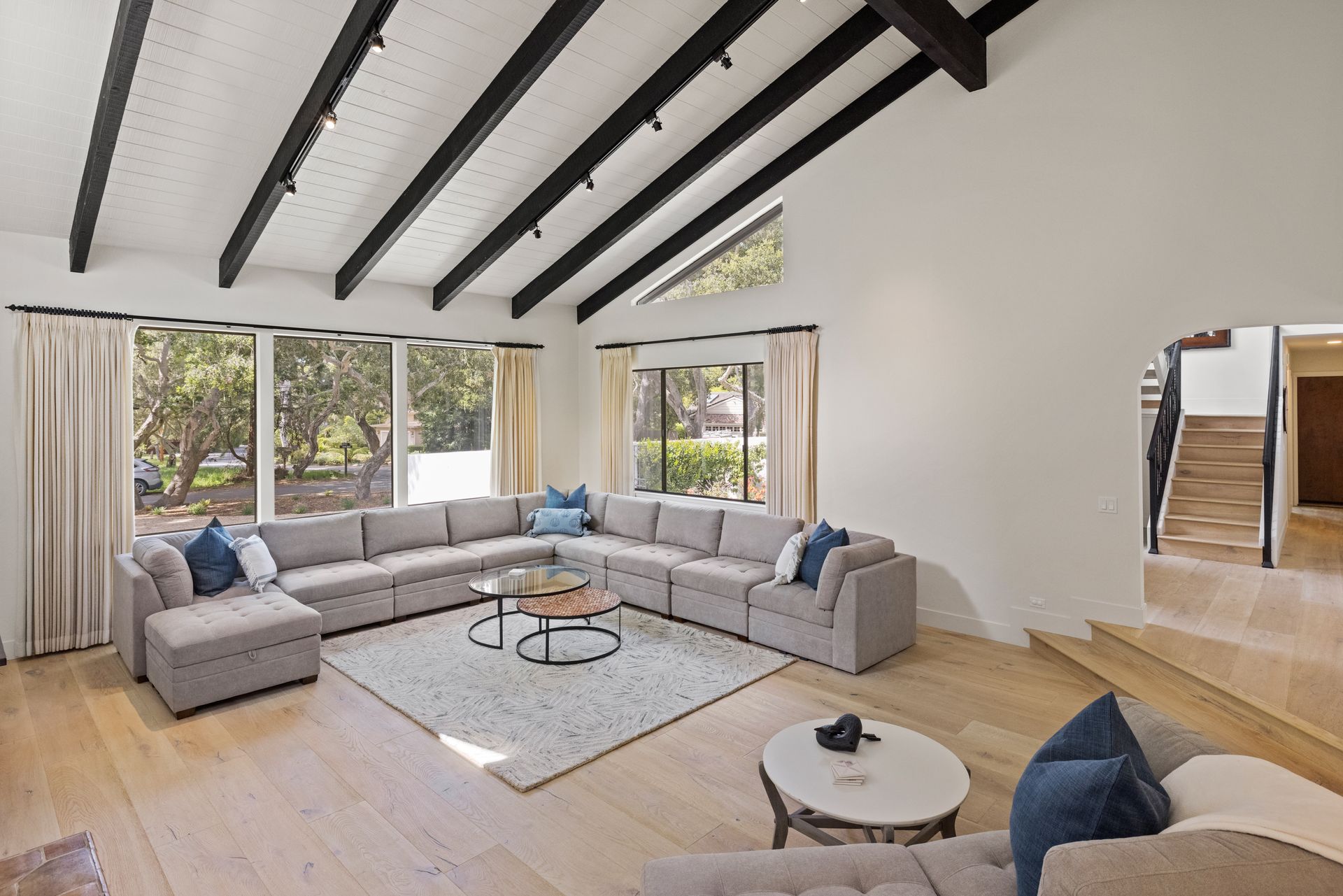 A living room with a large sectional couch and a coffee table
